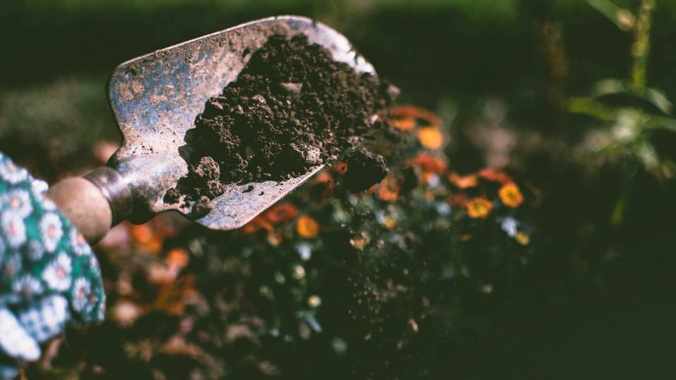 A spade with dirt on it